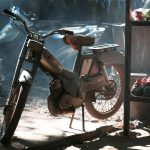 vintage motorbike standing in a garage
