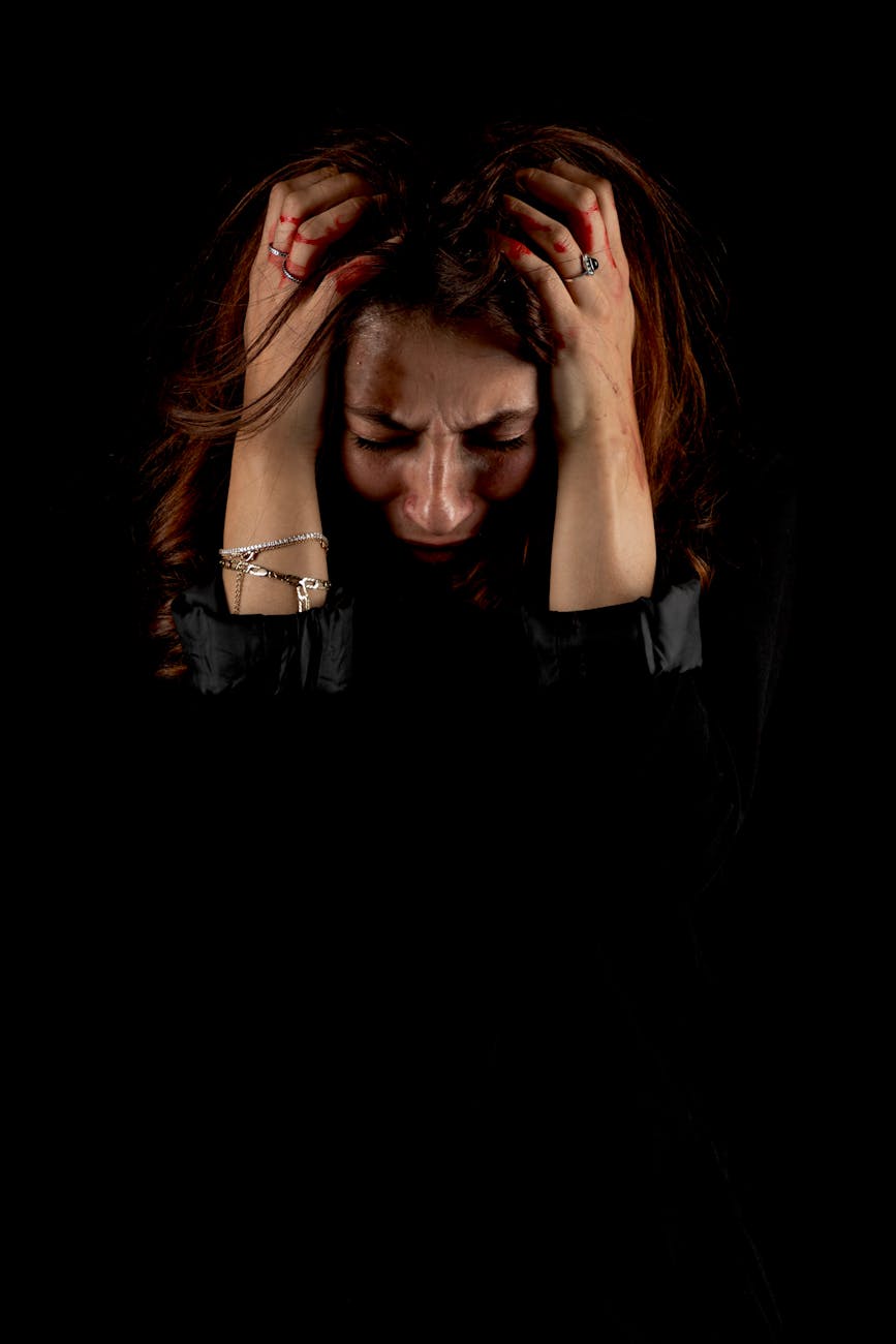 woman in emotional distress holding head