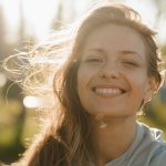 girl in white crew neck shirt smiling