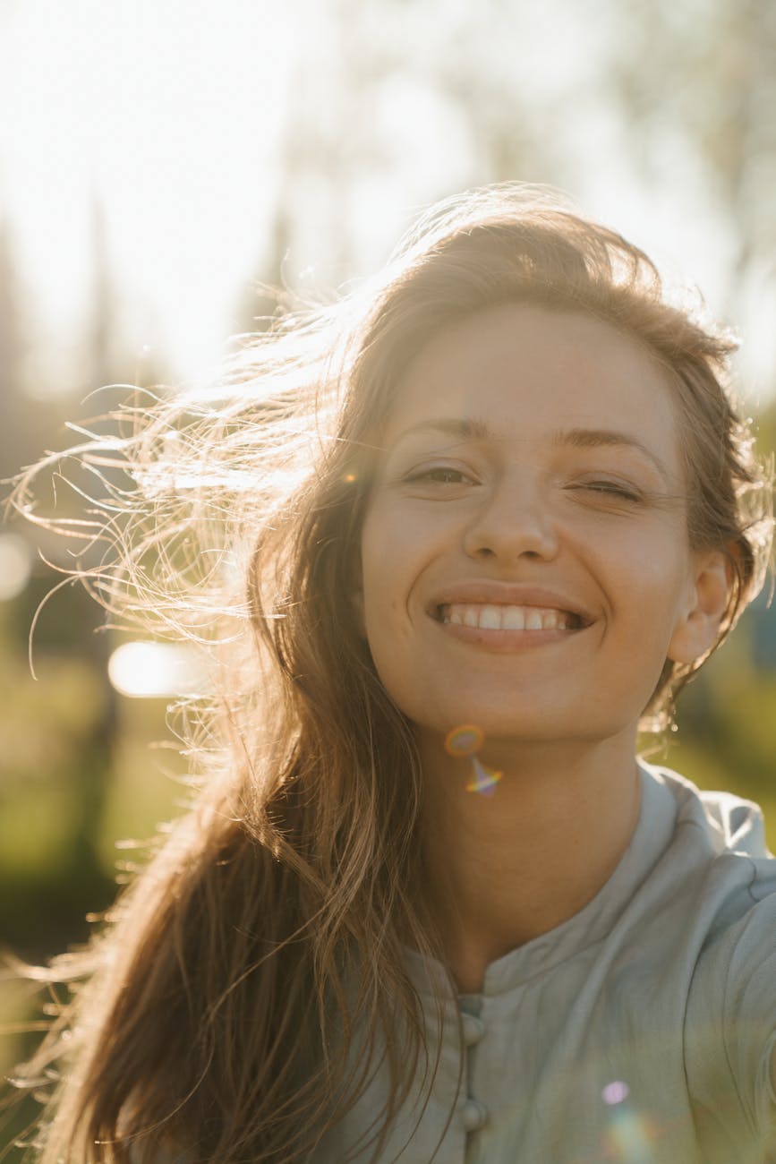 girl in white crew neck shirt smiling