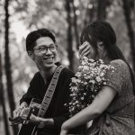 asian couple with guitar in park
