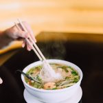 a bowl of pho on the table