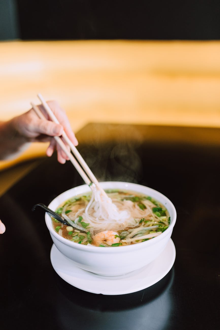 a bowl of pho on the table