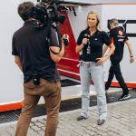 tv crew filming interview at raceway