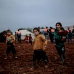 kids walking in muddy field