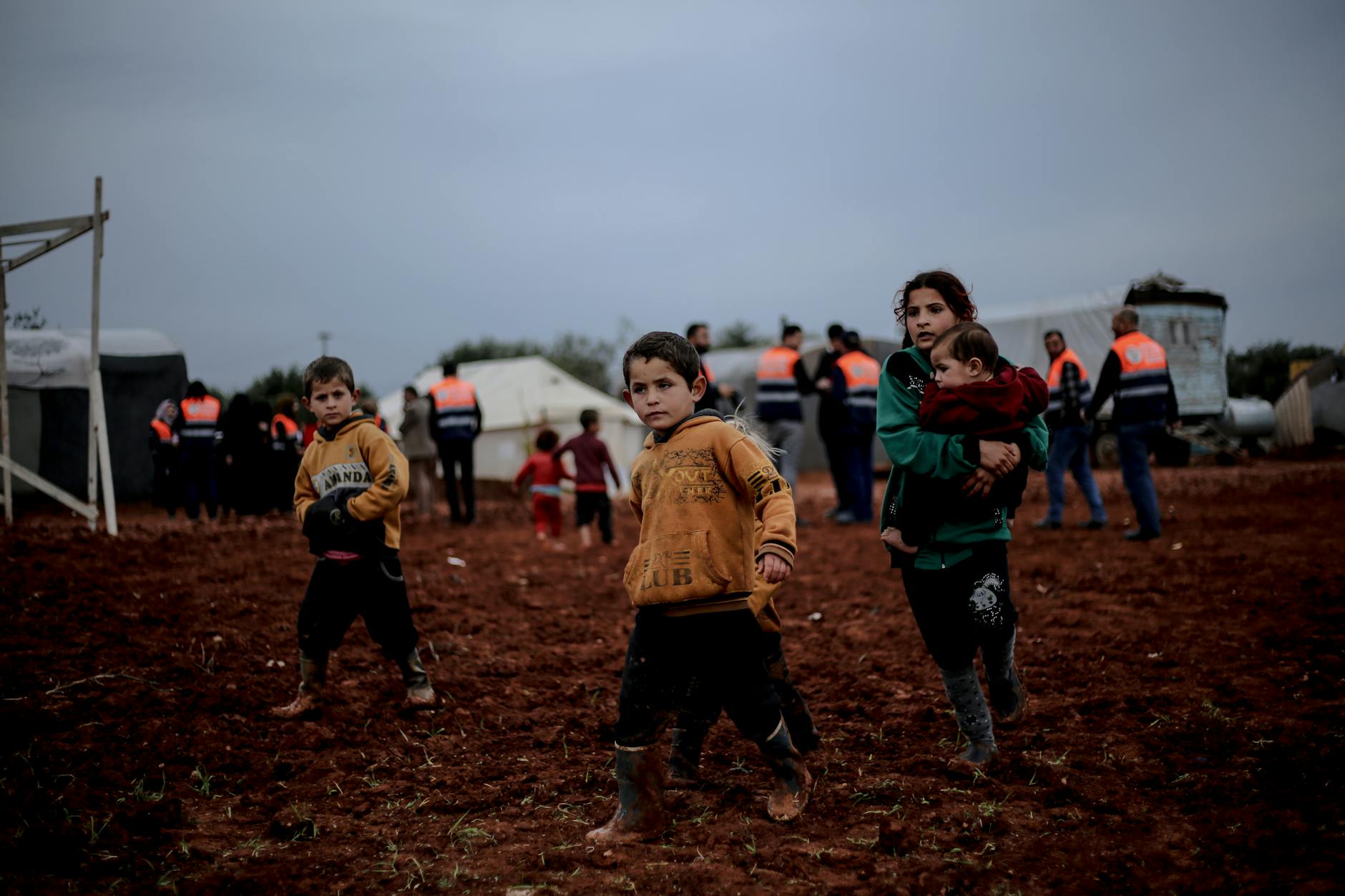 kids walking in muddy field
