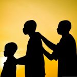 silhouette of boys standing together