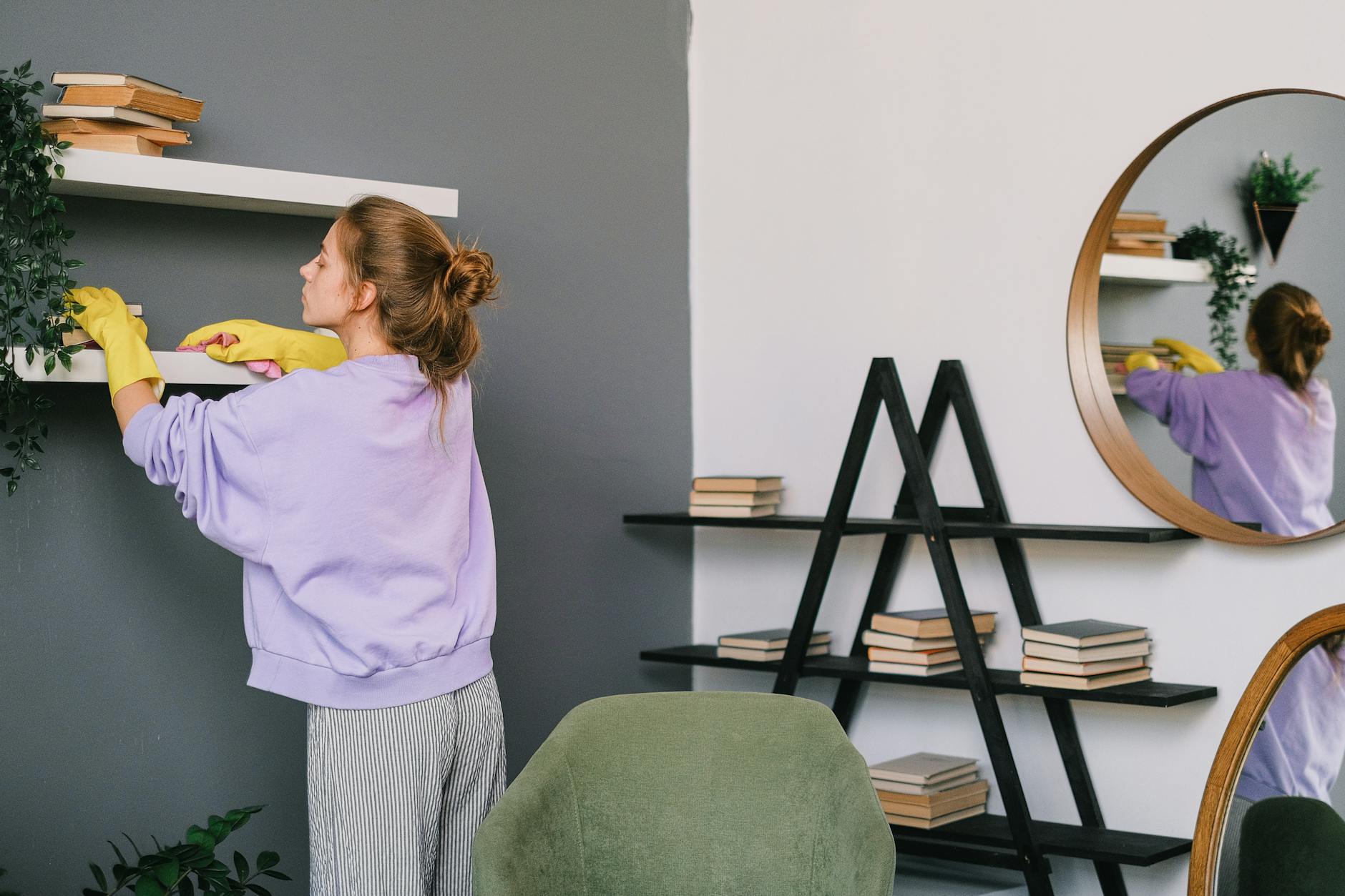 woman wearing gloves cleaning the shelves