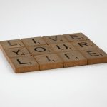 close up shot of scrabble tiles on a white surface