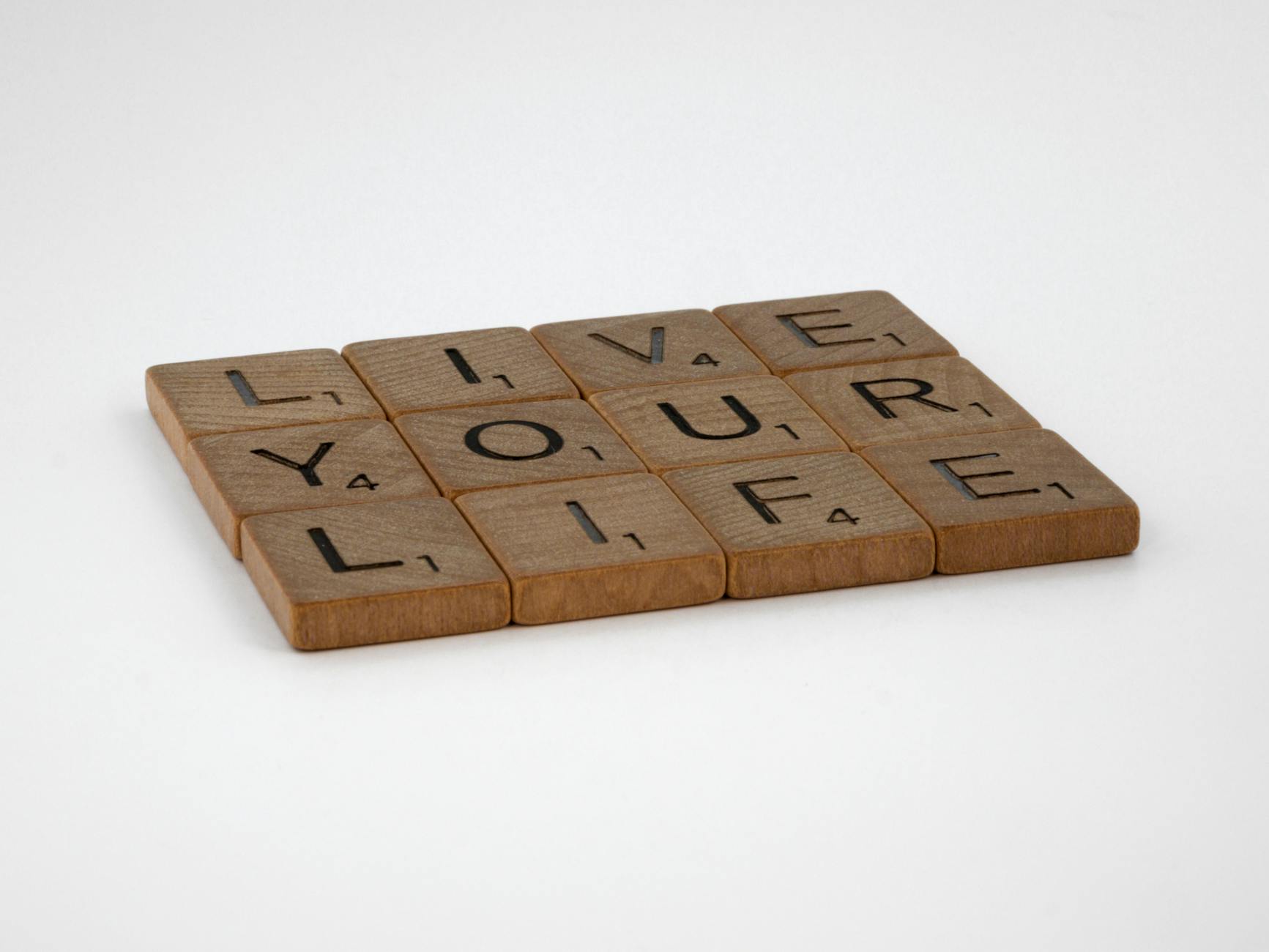 close up shot of scrabble tiles on a white surface