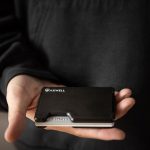 hand holding wallet with cards