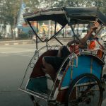 man lying down on rickshaw