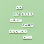 close up of motto from scrabble letters