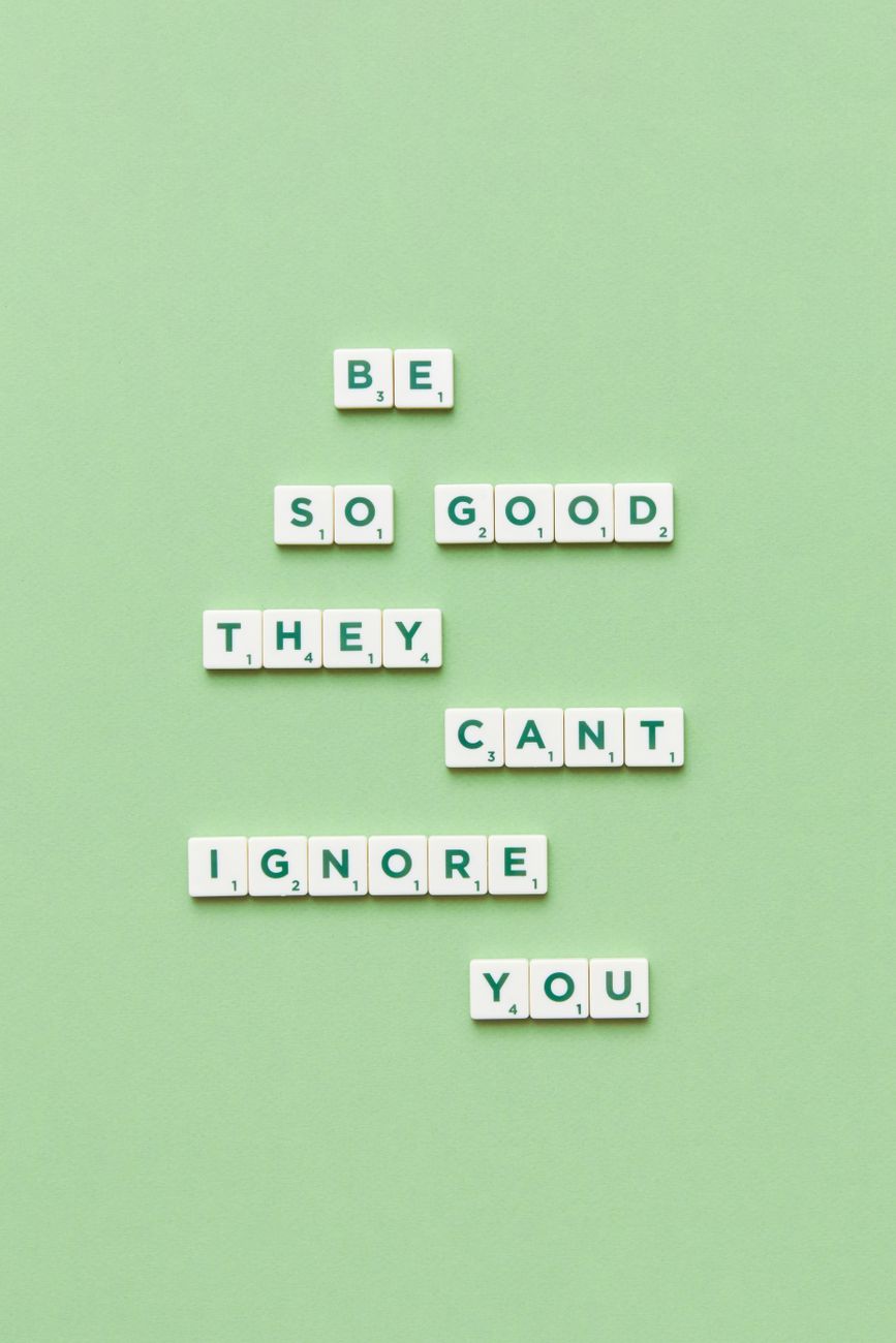close up of motto from scrabble letters