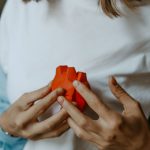 a woman holding an orange toy